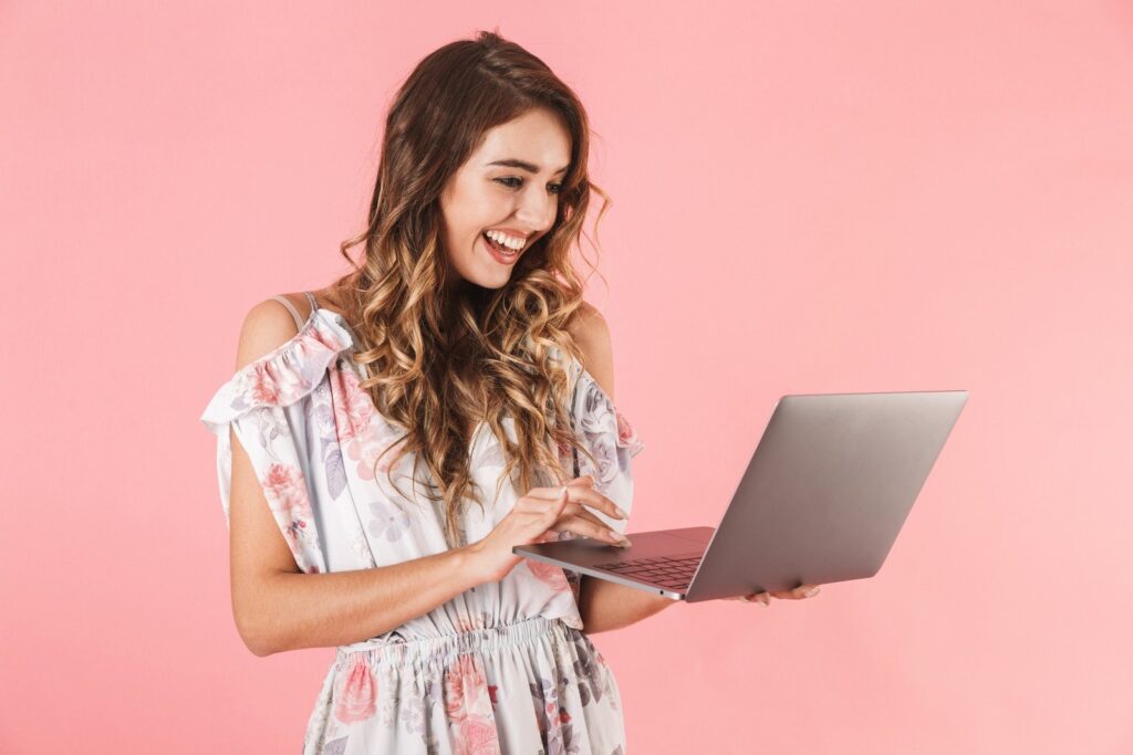 Professional female ecommerce seller using AI product listing generator software on laptop for Amazon eBay Walmart optimization
