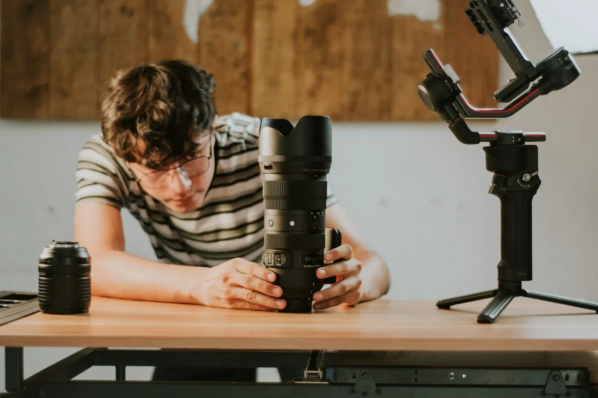 Seller inspecting a camera lens before describing its condition