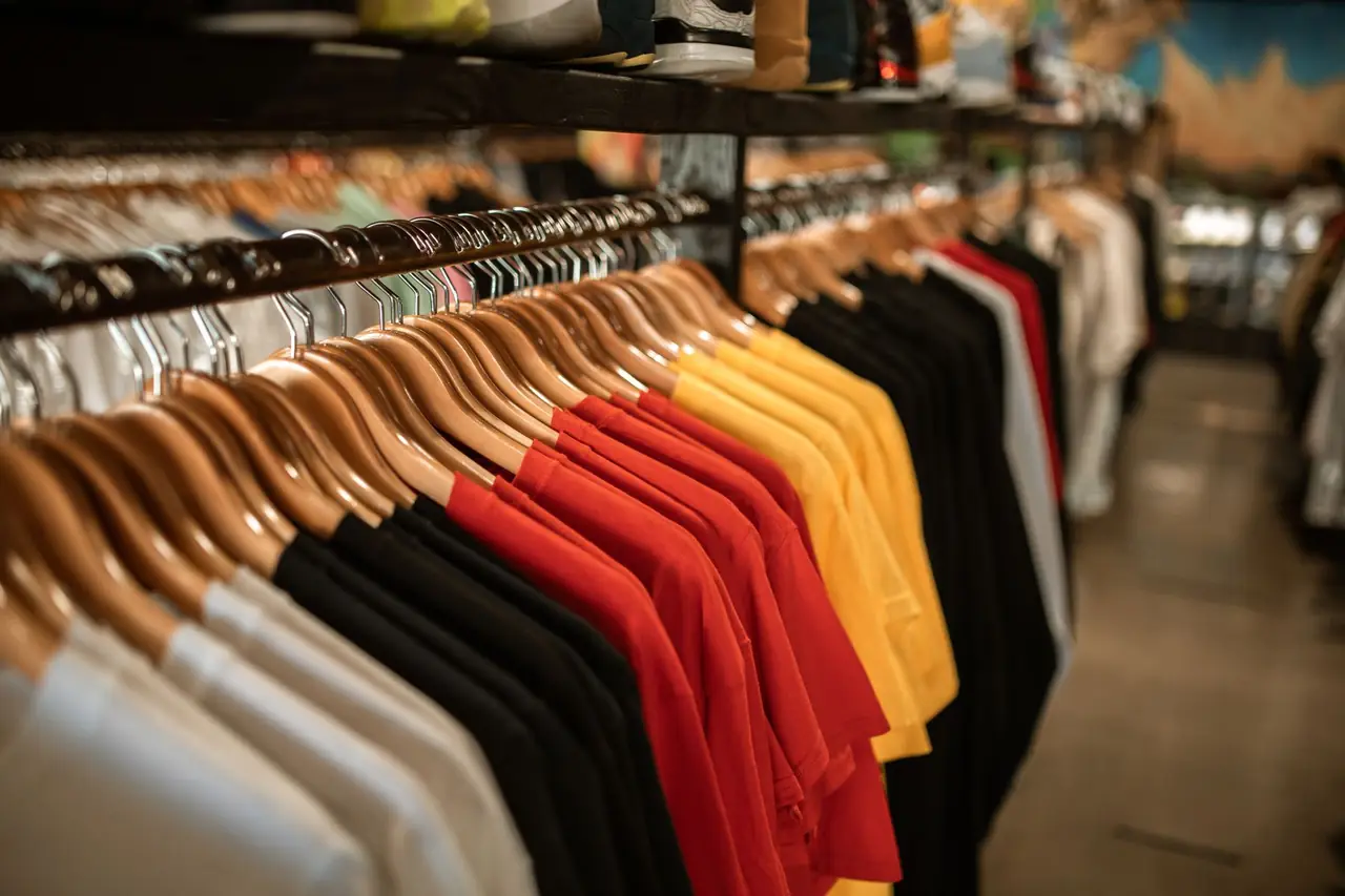 Shirts arranged by color on a clothing rack for variation planning